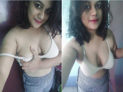 Adorable Desi woman with a great pair of tits removing her bra on XXX show