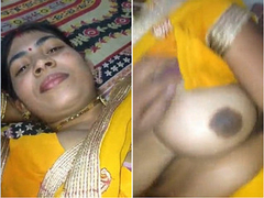 Sexy amateur Desi with massive boobs holding the camera as she is recording XXX