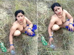Naked Desi woman with juicy natural boobs is squatting outdoors while XXX