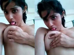 Desi coed with a cute face and massive boobs tries to suck on her nips XXX